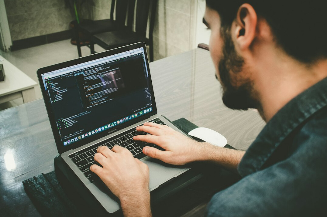 young person learning programming on laptop