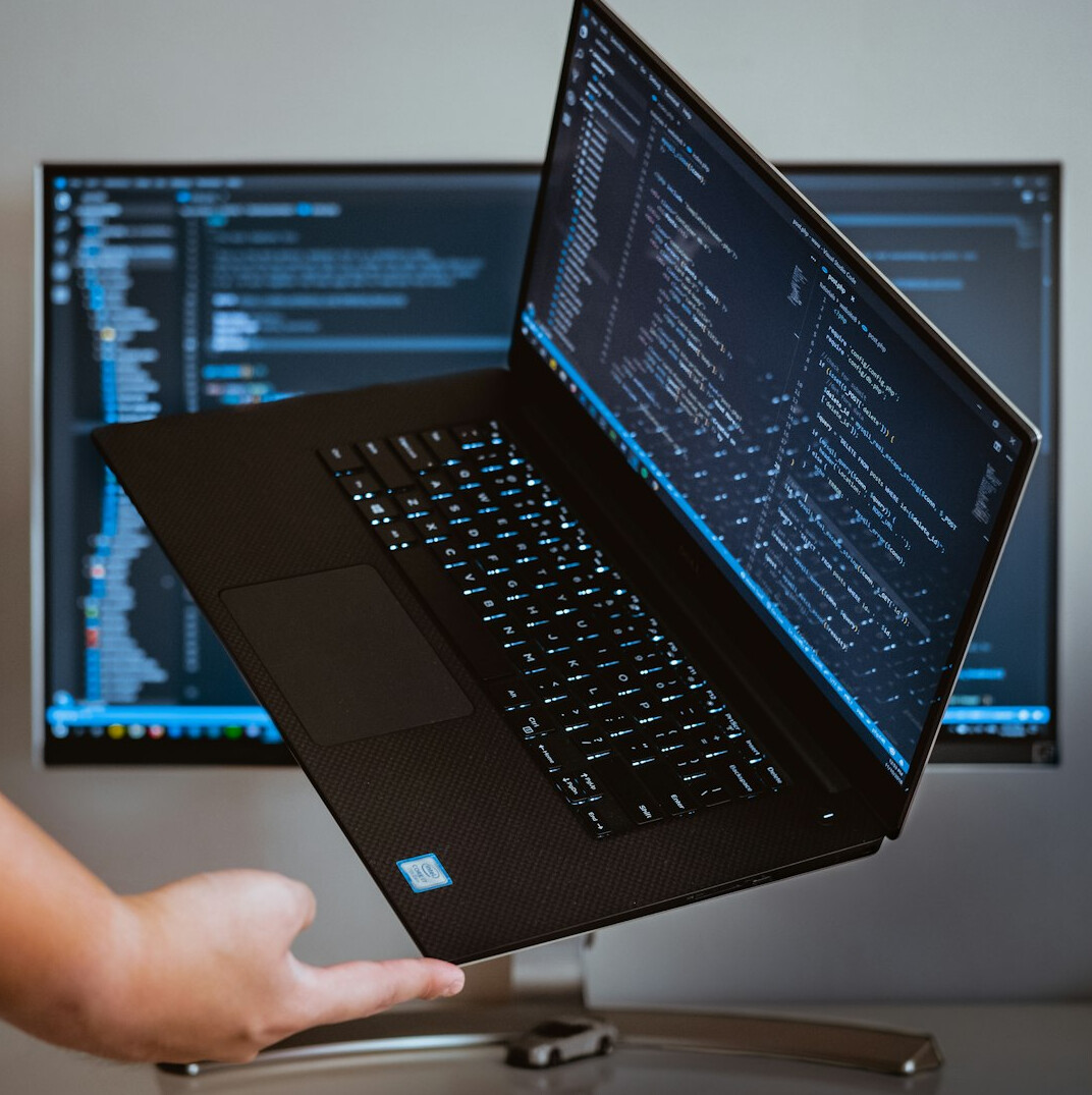 programmer coding on laptop