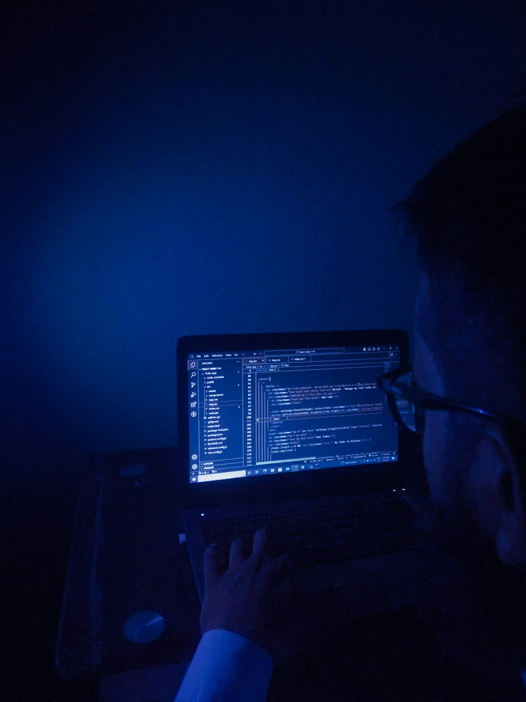 person coding on laptop
